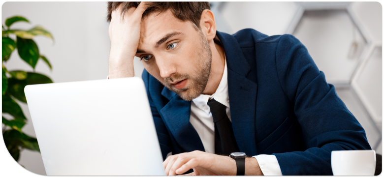 Empresário preocupado diante de um notebook